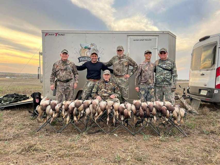Trophy group with Saskatchewan mallards and the Prairies Edge Outfitting trailer